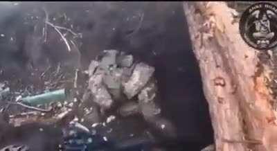 A Ukrainian soldier clears out a Russian foxhole in the Donbass