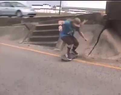 Guy skating on an exit ramp