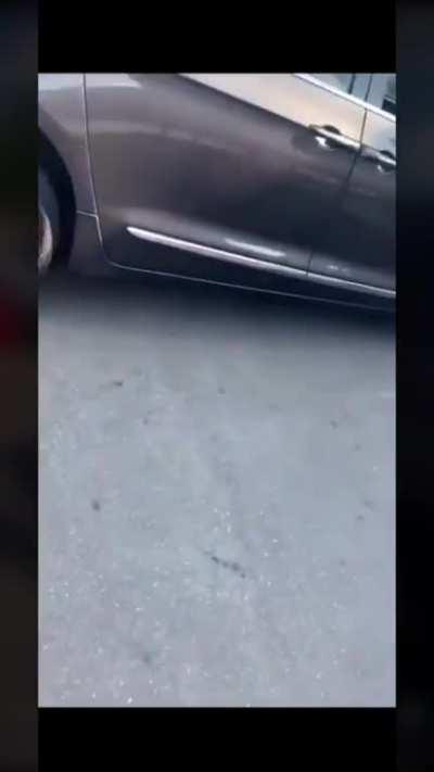 Lady brandishes over apparent fender bender.