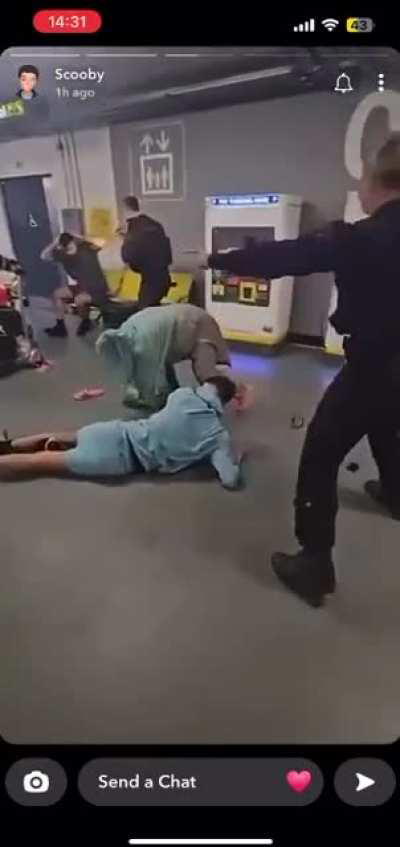 UK Police officer assaults person laying on the floor at Manchester Airport 