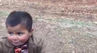 Turkish soldiers give chocolate to Syrian kid