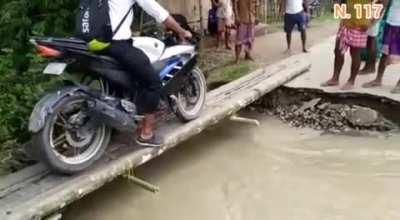 While crossing a narrow bridge on a motorcycle