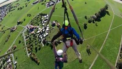 Guy is not strapped in to the hang glider