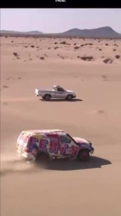 Saudi Villager Passes an Off-Road Racer During the Dakar Rally