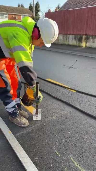 Road letters being painted in the UK