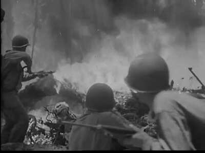 Japanese grenade goes off close to a Marine flamethrower in the Pacific jungle