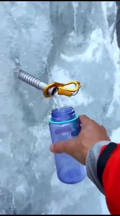 Using an ice screw to source water whilst ice climbing