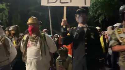 Wall of US miltary vets in Portland last night, standing at parade rest in solidarity