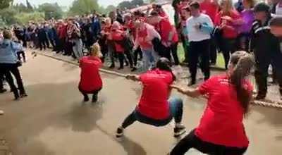 Woman pulls the wrong way in a tug-of-war match