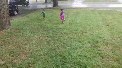 Kids enjoying playing in the rain after the recent heat wave