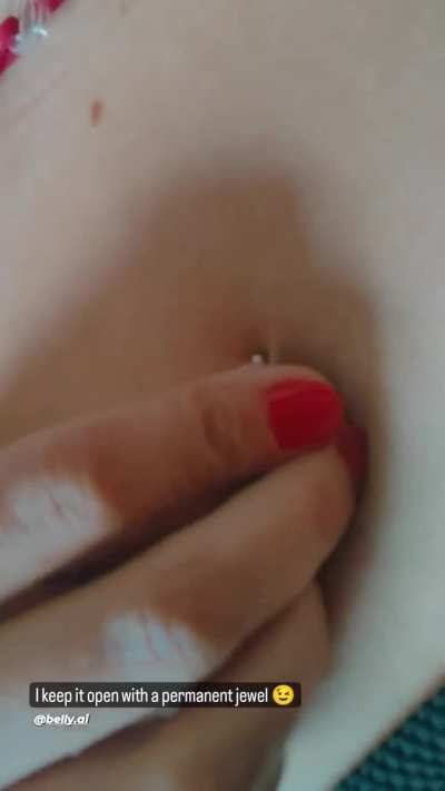 girl decorates her true navel piercing 