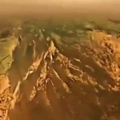 Huygens probe descending on the surface of the Titan, this landing on the Saturn's largest moon was possible because of NASA's Cassini probe..