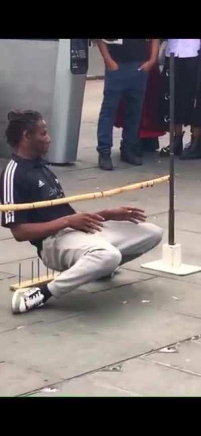 Mr. Limbo, a street performer in the London area, defying gravity with a bed of nails under him. Amazing what the human body can do!