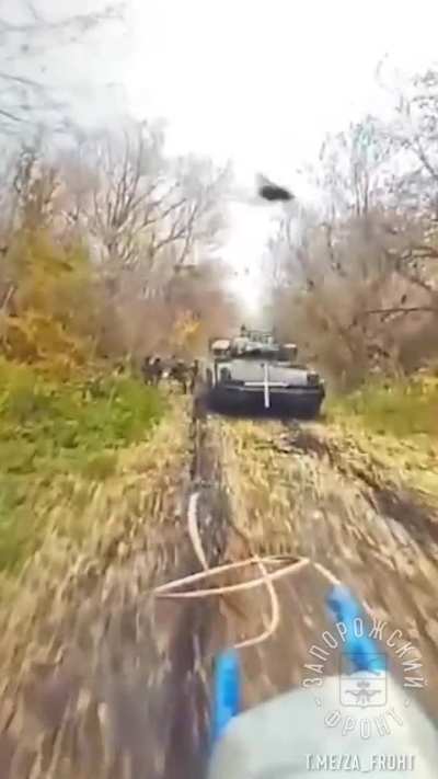 Russian FPV drone sneaks up on a group of Ukrainian soldiers and a Bradley in Kursk oblast