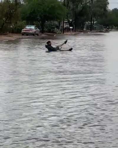 My boyfriend tubing down the river...I mean road next to our house in this mornings floods.