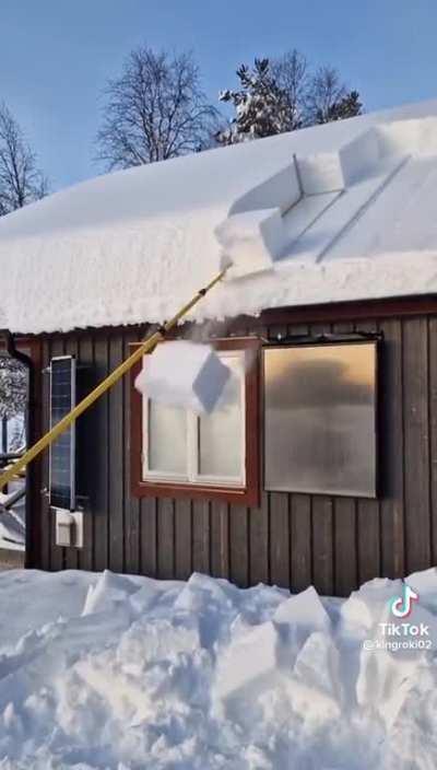 The way he removes the packed snow from the roof.