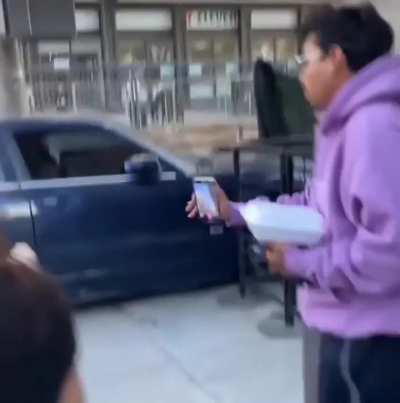 crazy lady with kids in car is determined to drive on the sidewalk