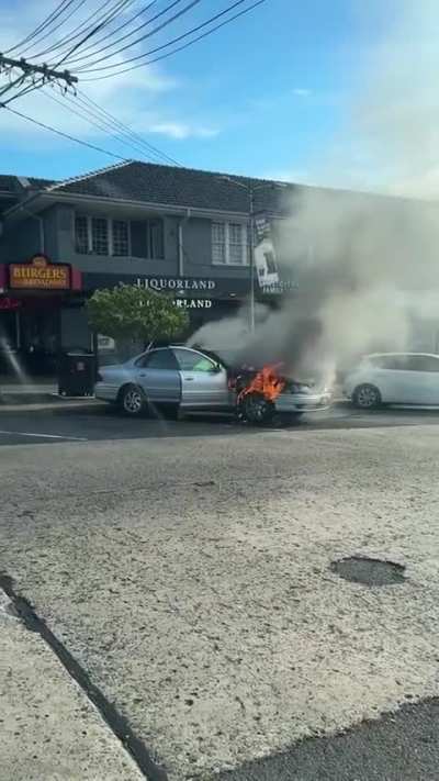 Aussie ignores the fact his car is on fire and loads it up with beer