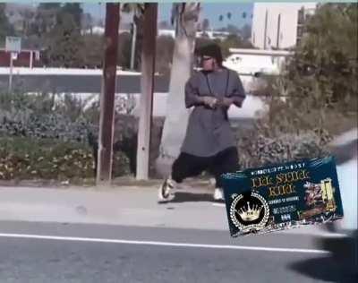 Gang member in Los Angeles mobbing down the street.