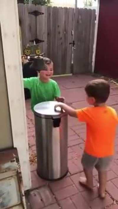 Kids playing with trash can