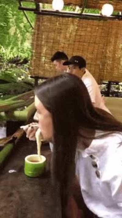 Interesting how noodles are served through bamboo in a kyoto restaurant. Japan.