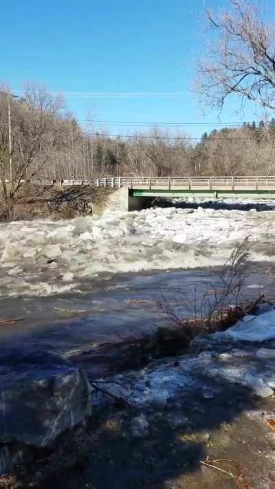 The moment an ice dam breaks and causes a torrential water flow.