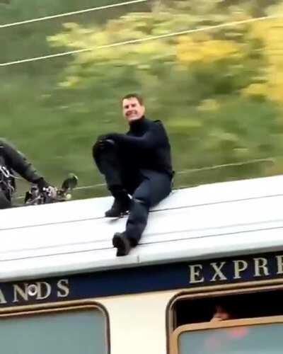 Tom Cruise chilling on top of a train whilst filming Mission Impossible 7