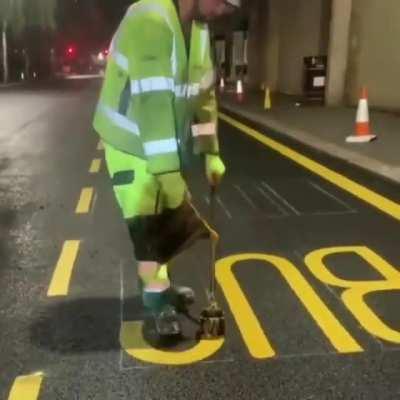 Worker Showcases Smooth Road Marking Skills