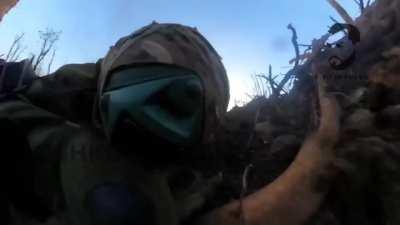 ru pov. Russian soldier bounces a live grenade off a tree and then slaps it away from himself