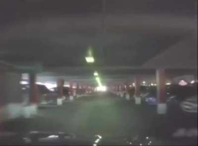 Russian drives out of a parking lot. (Not from ground level)