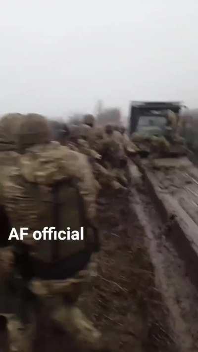 Ukrainian troops prepare to pull their transport out of the mud: When you don't have a recovery vehicle, but the truck is full of soldiers, the old-fashioned way can still get you unstuck!