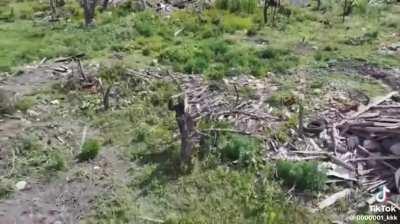 African mercenary(?)  attempting to hit a Ukranian drone with a stick