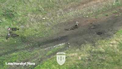 Russian BMP-2 hits a mine, dismounts are subsequently hit with drone dropped grenades near Ivanivka, Kharkiv region [deleted]