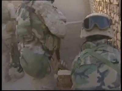 US Marines participating in Operation Phantom Fury are stuck on a rooftop of an insurgent infested building and trade small arms fire and insults as they search for a safe way off the roof.