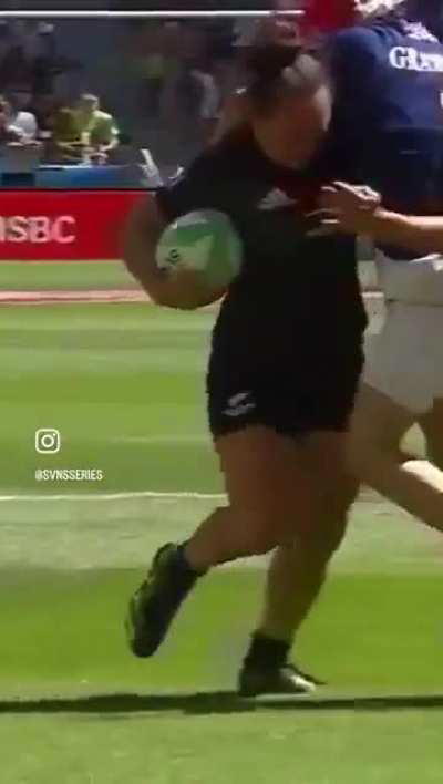 Woman rugby player bulldozes through opposing players