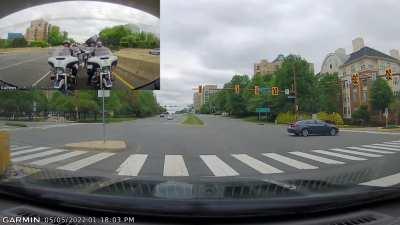 Car runs red outside of RTC in front of 6 motorcycle Police.