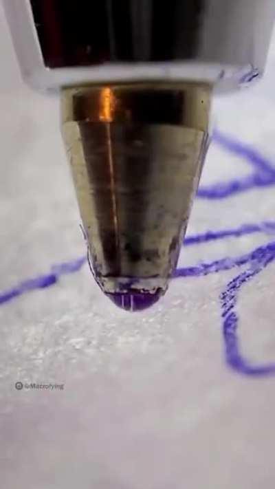 The ball of a ballpoint pen is rolling.