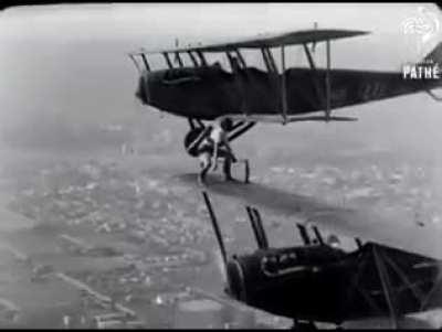 A woman replaces the wheel of a plane mid-flight.