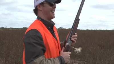 Man catches flying bird with bare hand