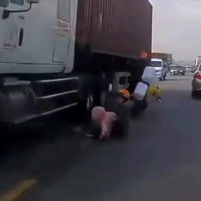 Mother saves son from being crushed under the wheels of truck with lightning fast reactions in heart-stopping footage