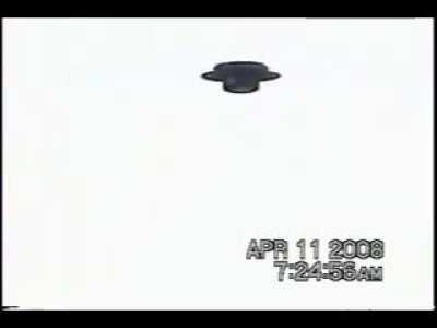 Silent UFO hovers over mans backyard in 2008 in Houston, Texas. . At the end you hear his dog barking at it.