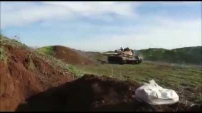 T-55 reverses just in time to avoid getting hit by an ATGM, while the loader bails.