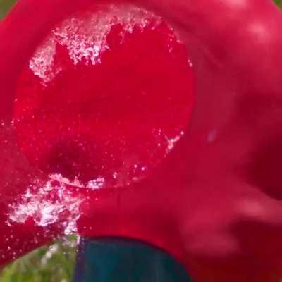 Water balloon getting obliterated by a baseball in slow mo