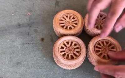 Hand carving a Land Cruiser from a block of wood.