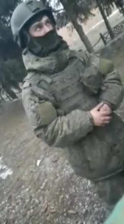 A civilian is talking to a Russian soldier in the city of Sumy. Ukraine.