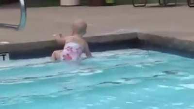 Elizabeth swims across the pool for the first time.