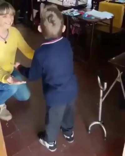 This young man has cerebral palsy. He took his first steps today without his cane as classmates cheered him on.