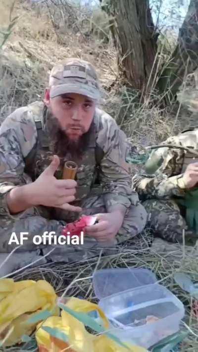 Ukrainian soldiers enjoy an iconic Kherson watermelon in the field.