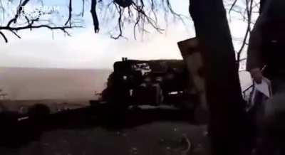 Ukrainian border guards posted footage of them using a MT-12 anti-tank gun against Russian vehicles with help of a drone (Music from source)