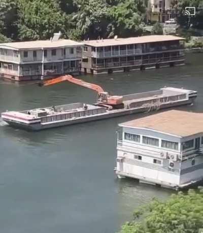 An excavator rowing in the Nile, Egypt.